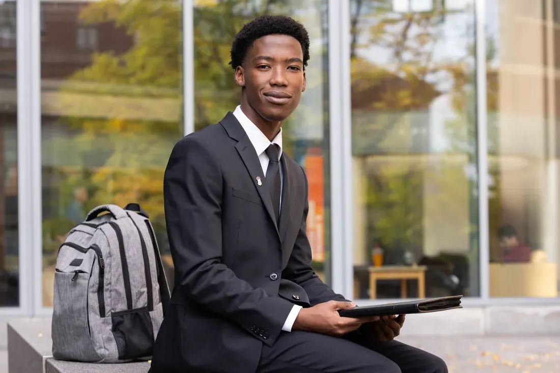 Student sitting and smiling.